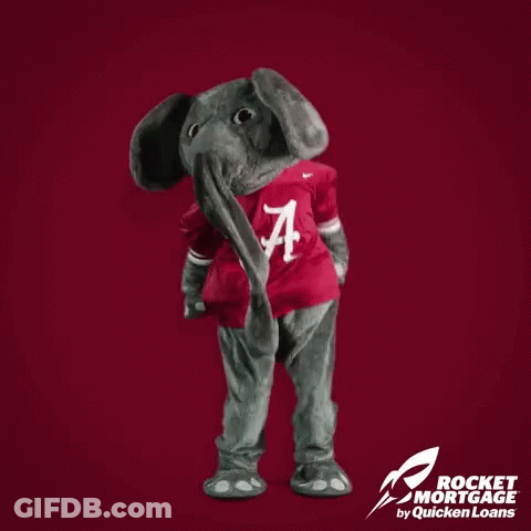 Alabama Mascot Standing In Front Of Red Background Saying Alabama Wins GIF