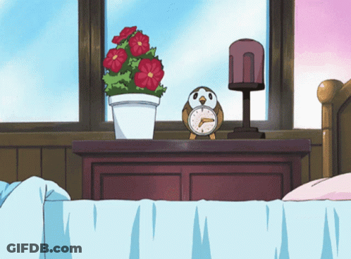Alarm Clock On Nightstand Next To Plant GIF