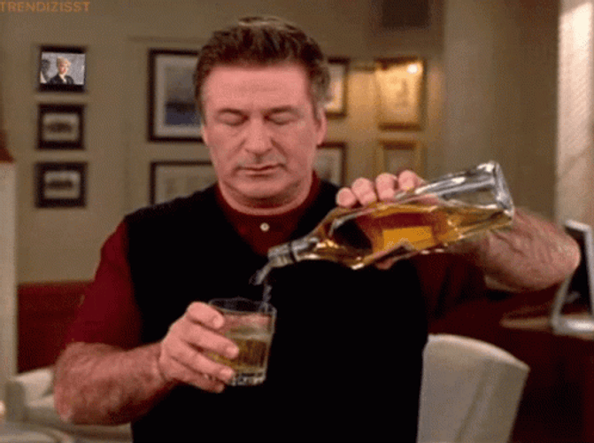 Alec Baldwin Pouring Whiskey On The Glass GIF