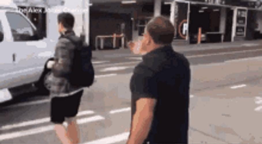 Alex Jones Chasing Guy Cross Street GIF
