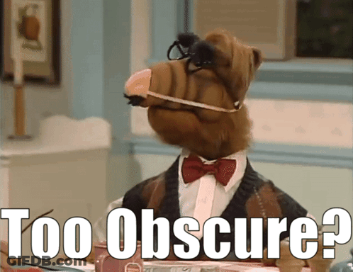 Alf From The Show Sits At A Table With The Words Too Obscure Written Below Him GIF