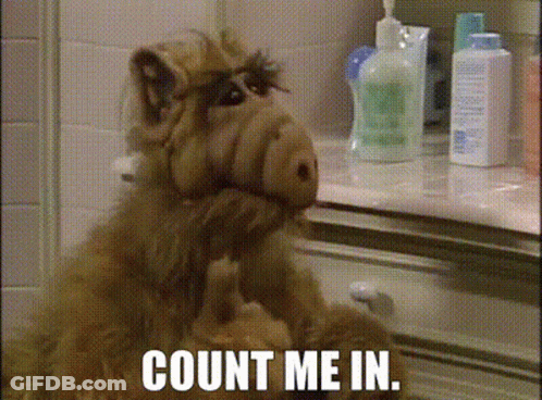 Alf From The Sitcom Sits In Front Of A Counter With The Words Count Me In Written On It GIF