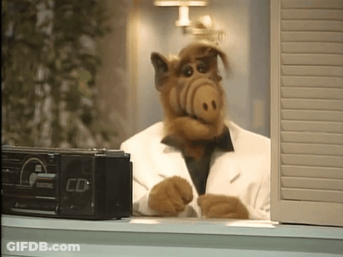 Alf From The Sitcom Sits In Front Of A Radio That Says Cd GIF