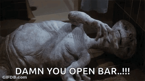 Alien Statue Laying On Floor Saying Damn You Open Bar GIF