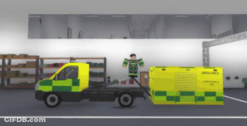 Ambulance Being Pulled By Truck In Garage GIF