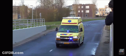 Ambulance Driving Down Street With License Plate XS-KZP GIF