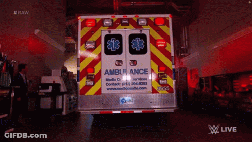 Ambulance Parked In Dark Room With Man In Suit GIF