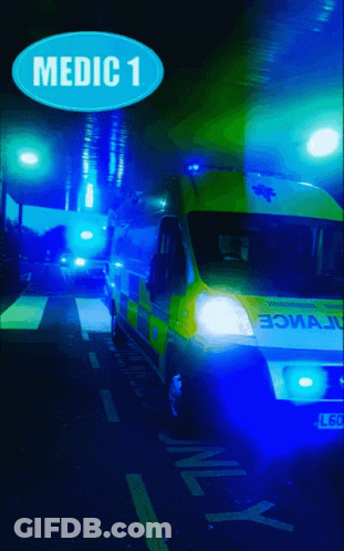 Ambulance Parked Under Blue Medic 1 Sign GIF