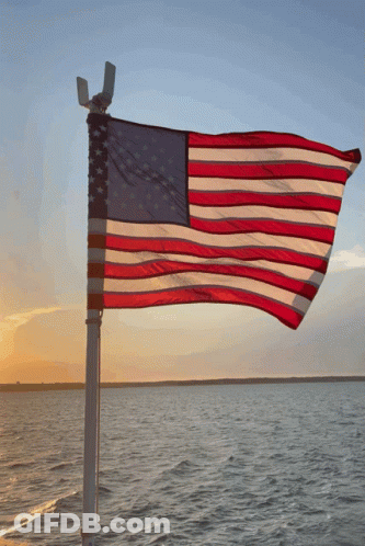 American Flag Over Water At Sunset GIF