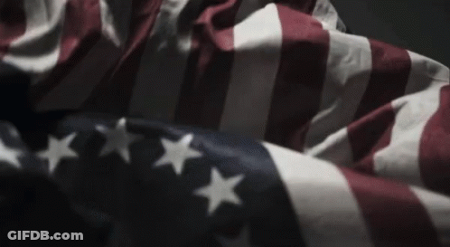 American Flag Waving In Wind In Dark Room GIF