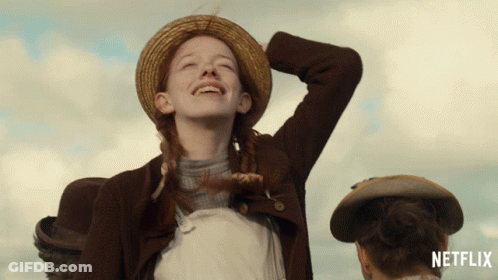 An Advertisement For Netflix Shows A Girl In A Straw Hat Laughing GIF