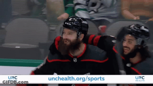 An Advertisement For Unc Health Shows Hockey Players On The Ice GIF