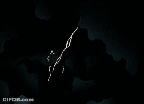 An Aerial View Of A Building With A Few Windows Lit Up At Night GIF
