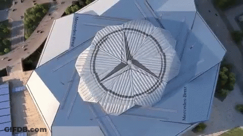 An Aerial View Of A Building With Mercedes Benz Written On It GIF