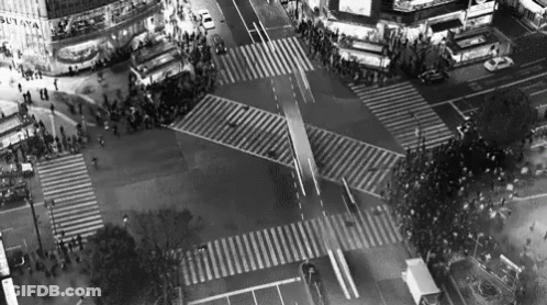 An Aerial View Of A Busy Intersection With A Building That Says Sutaya On It GIF