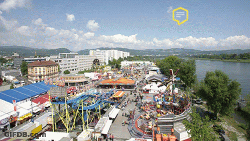 An Aerial View Of A Carnival With A Yellow Speech Bubble That Says ' E ' On It GIF