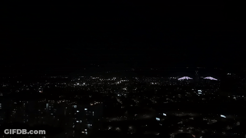 An Aerial View Of A City At Night With A Lot Of Lights On GIF