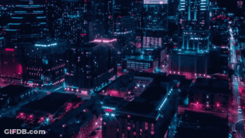 An Aerial View Of A City At Night With A Sign That Says ' City Square ' On It GIF