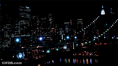 An Aerial View Of A City At Night With A Sign That Says ' Empire ' On It GIF