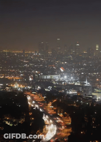 An Aerial View Of A City At Night With Lots Of Lights GIF