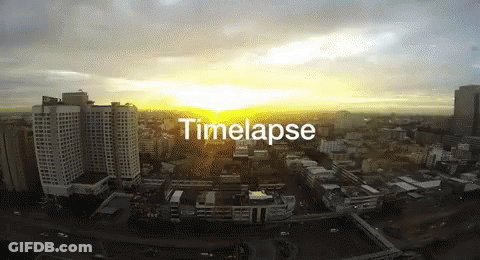 An Aerial View Of A City At Sunset With The Words Timelapse Below It GIF