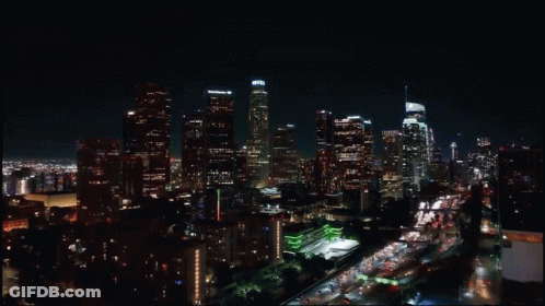 An Aerial View Of A City Skyline At Night With A Few Buildings Lit Up Including One That Says Chase GIF