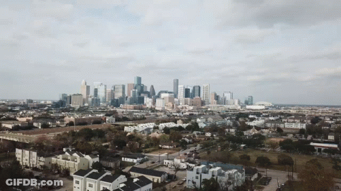 An Aerial View Of A City Skyline With A Lot Of Buildings GIF
