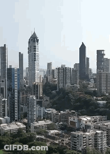 An Aerial View Of A City Skyline With Lots Of Tall Buildings GIF