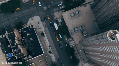 An Aerial View Of A City Street With A Building That Has The Letters Bb On It GIF