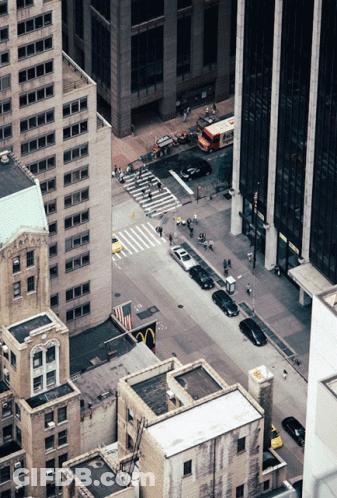 An Aerial View Of A City Street With A Mcdonald 'S In The Middle Of It GIF