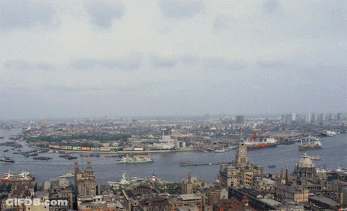 An Aerial View Of A City With A Clock Tower In The Middle Of The Water GIF