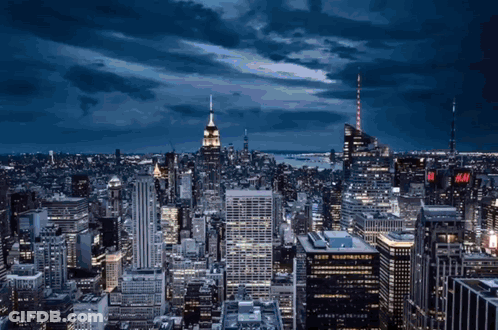 An Aerial View Of A City With A H & M Sign On The Top Of A Building GIF