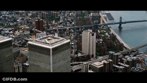 An Aerial View Of A City With A Helicopter On Top Of One Of The Buildings GIF