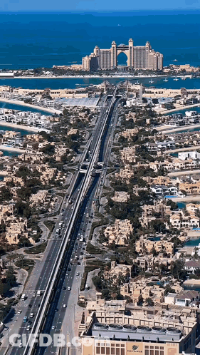 An Aerial View Of A City With A Large Hotel In The Background GIF