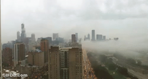 An Aerial View Of A City With A Lot Of Buildings GIF