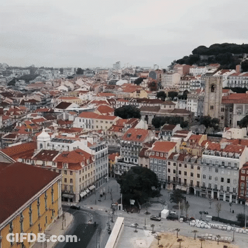 An Aerial View Of A City With A Lot Of Buildings GIF