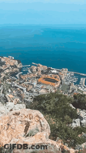 An Aerial View Of A City With A Stadium In The Middle GIF