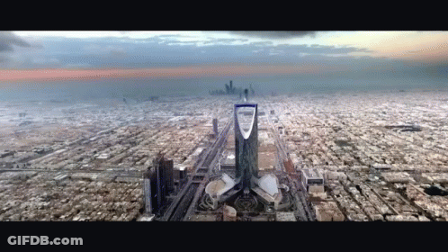 An Aerial View Of A City With A Tower In The Middle GIF