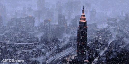 An Aerial View Of A City With A Very Tall Building In The Middle GIF