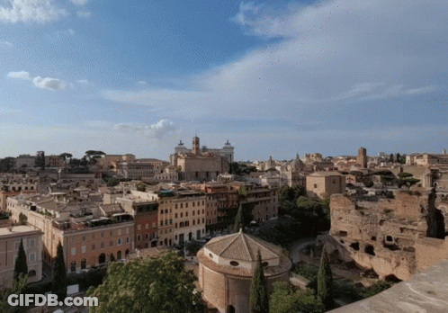 An Aerial View Of A City With Buildings And Trees GIF