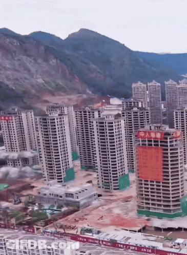 An Aerial View Of A City With Chinese Writing On A Building GIF