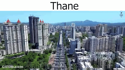 An Aerial View Of A City With Lots Of Tall Buildings And Trees GIF