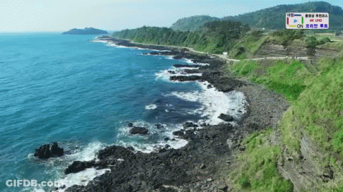 An Aerial View Of A Cliff Overlooking A Body Of Water With A Sign That Says 4K Live GIF