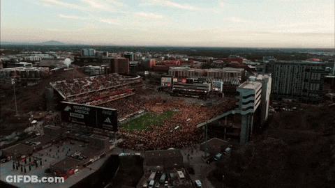 An Aerial View Of A Football Stadium With A Mountain Dew Billboard GIF
