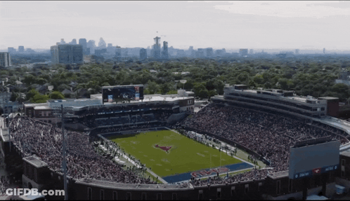 An Aerial View Of A Football Stadium With A Pepsi Ad On The Scoreboard GIF