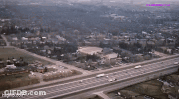 An Aerial View Of A Highway Going Through A Residential Area With The Words Imgflip.com At The Bottom GIF