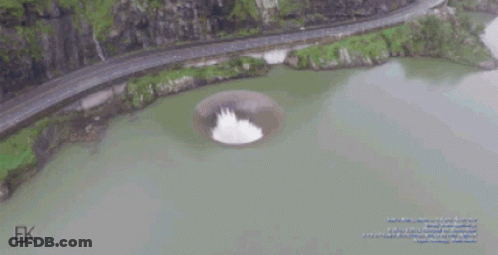 An Aerial View Of A Lake With A Hole In The Middle Of It GIF