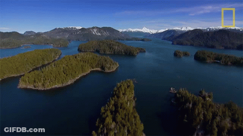 An Aerial View Of A Lake With Mountains In The Background And A National Geographic Logo GIF