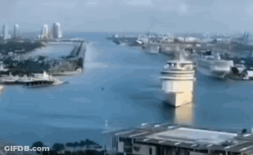 An Aerial View Of A Large Body Of Water Surrounded By Buildings GIF