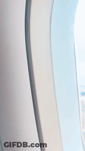 An Aerial View Of A Parking Lot From A Plane Window GIF